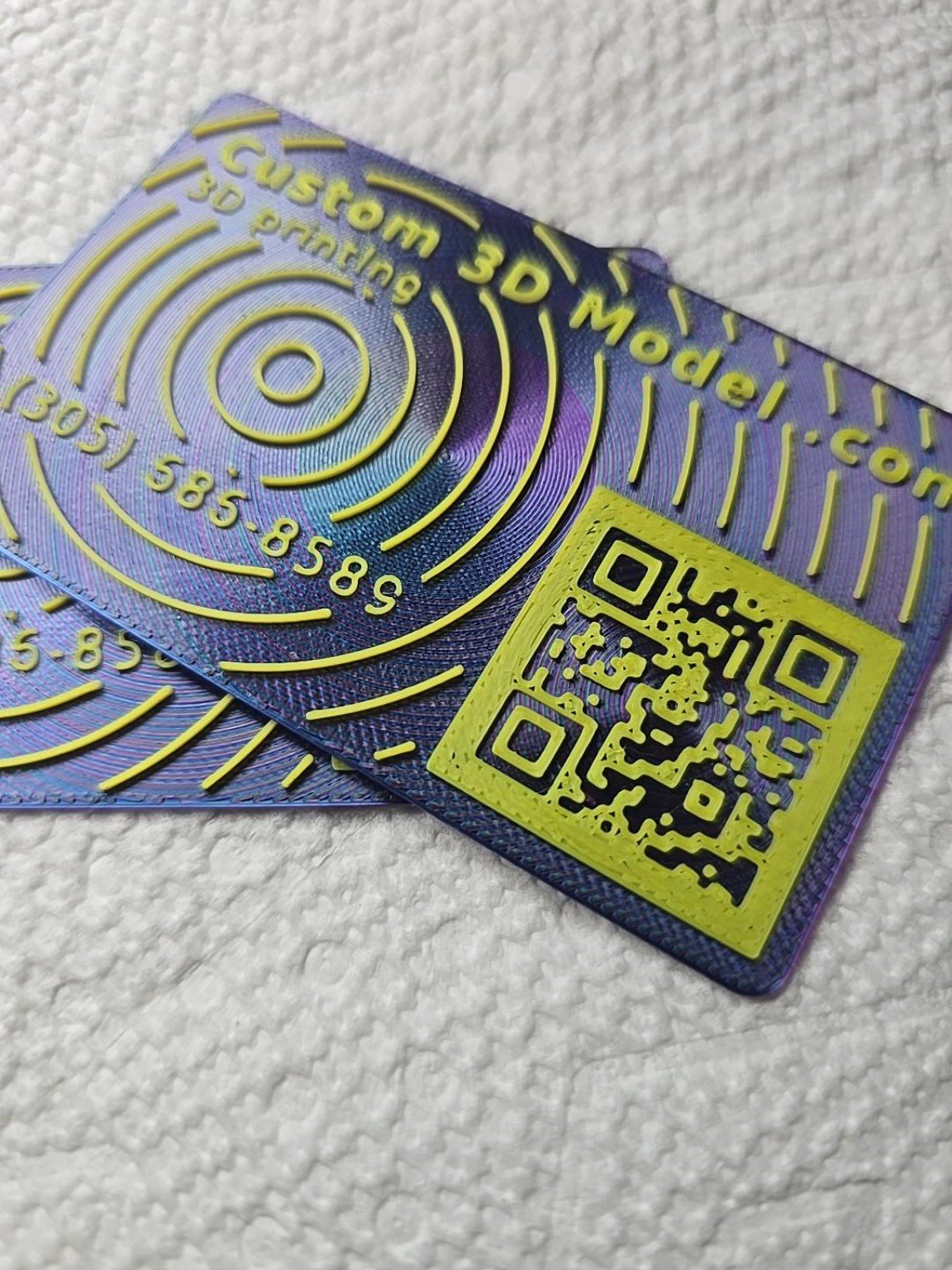 Close-up showing the raised printed texture of a 3D business card